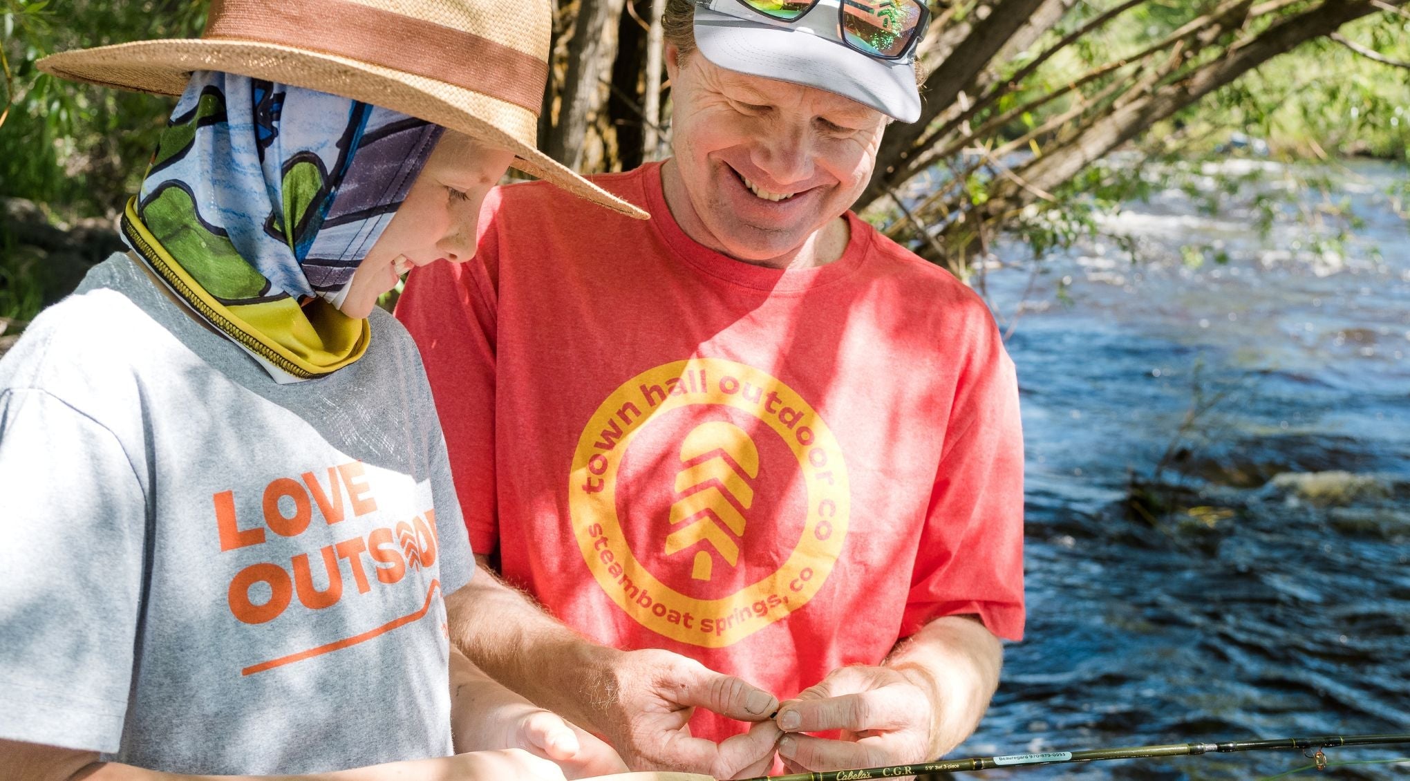 father and son flyfishing on a river in town hall tees