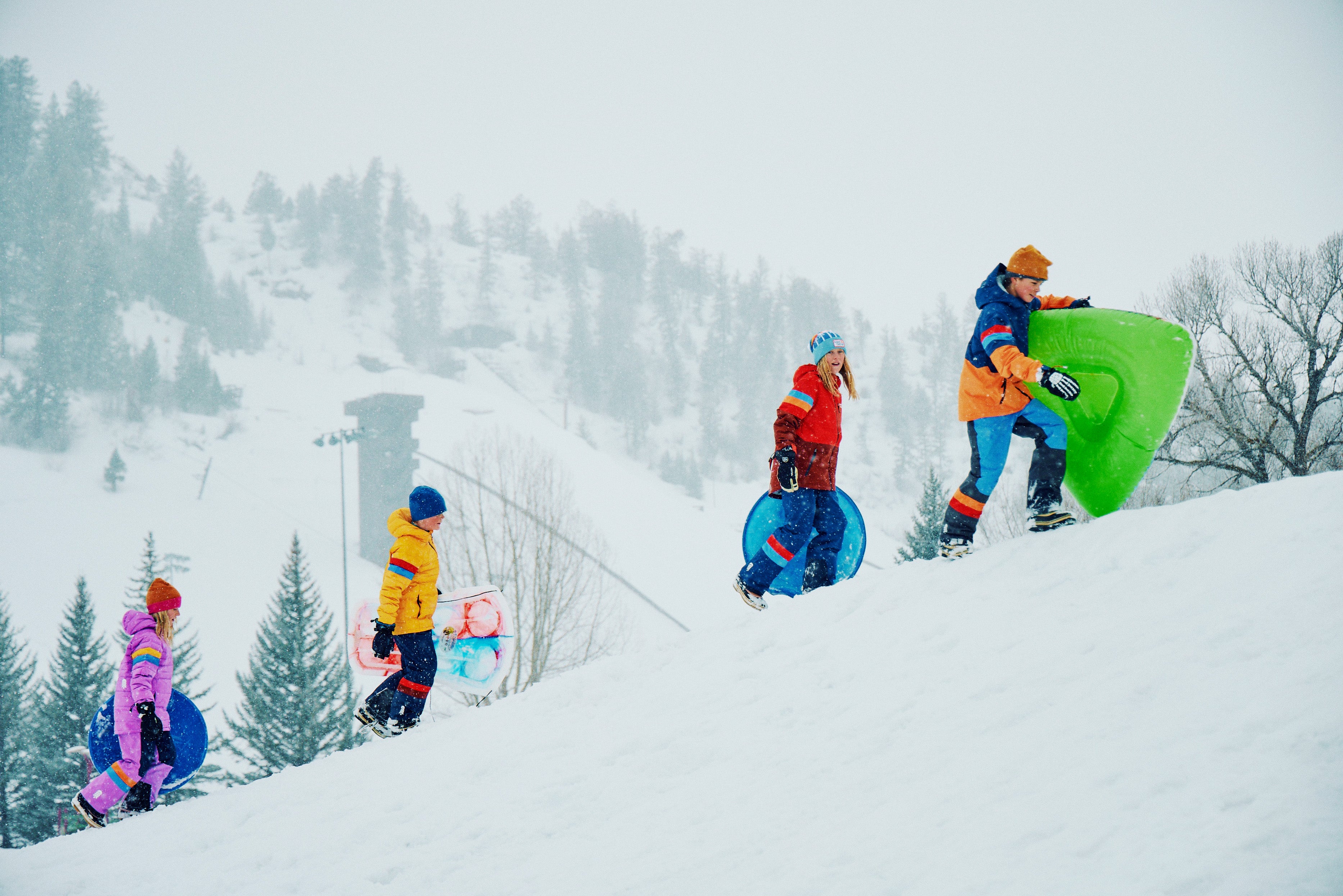 kids hiking uphill in snow