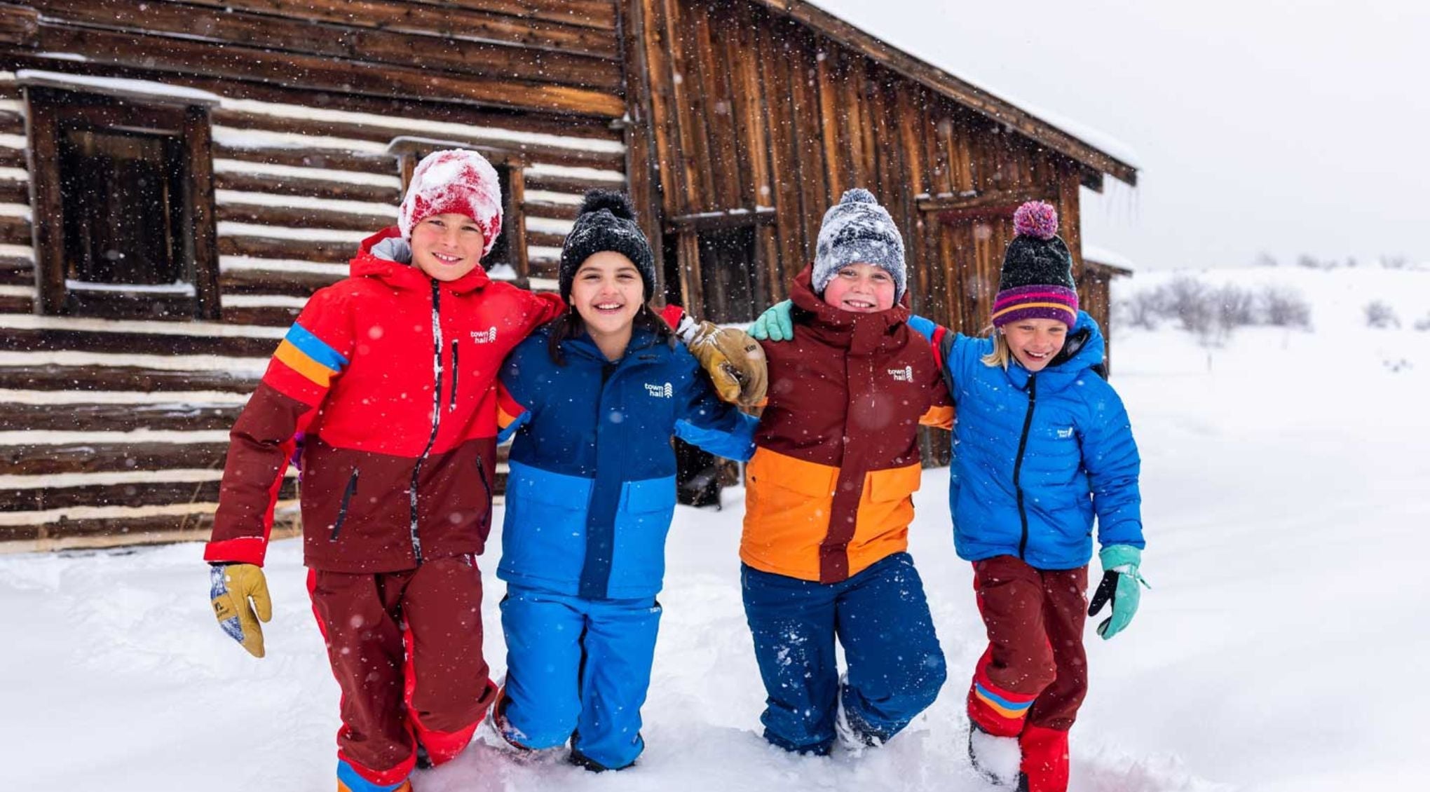 Kids sledding blissfully in Town Hall outerwear