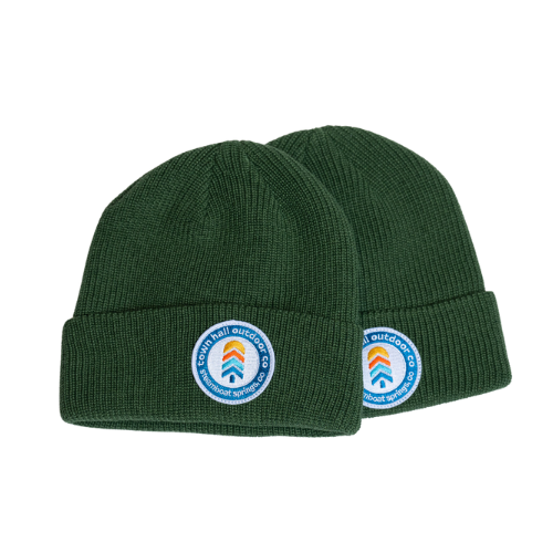 Two forest green Logo Knit Beanies showing the Town Hall front logo design and ribbed texture, versatile winter warmth that fits both adults and kids.