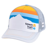 Angled view of mountain-print Town Hall Trucker Hat with white curved brim, gray mesh and BOCO Gear side label.