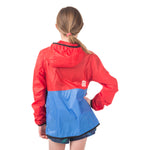 Girl adventurer showing the reflective safety details on the back of the Goji Berry Anorak, perfect for visibility during evening outdoor activities.