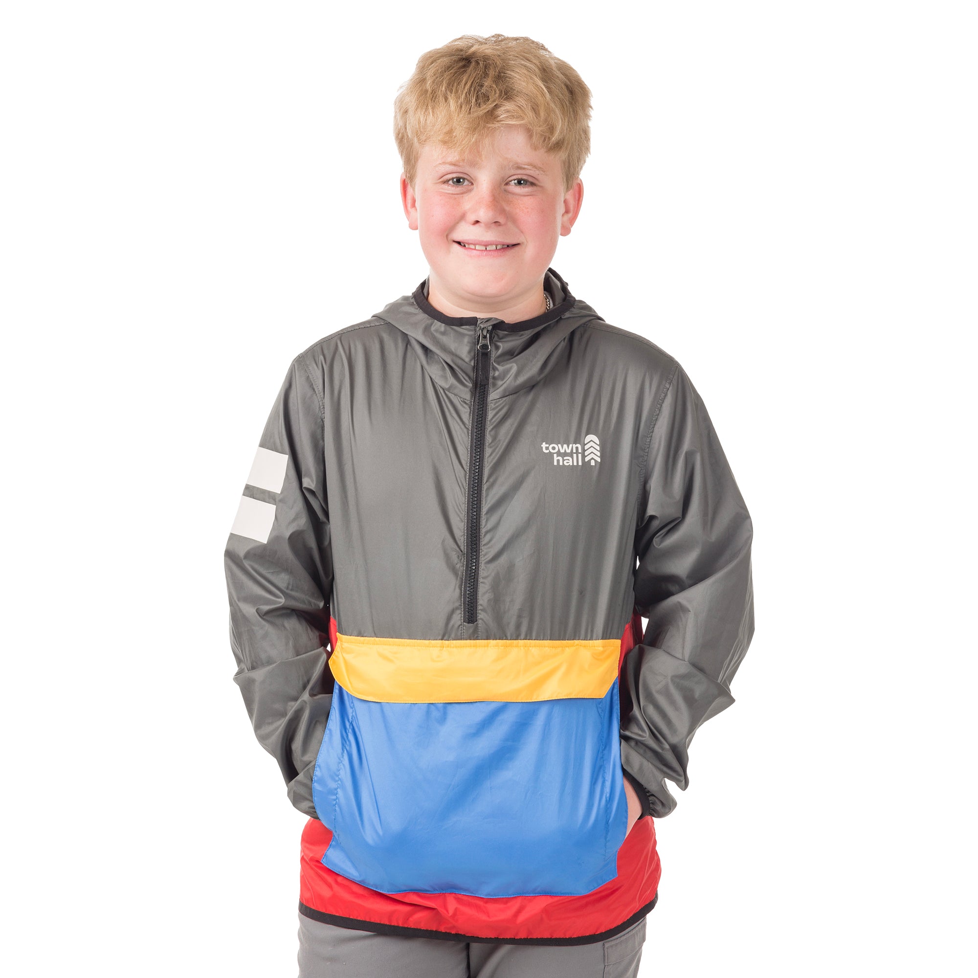Young adventurer in the Dark Shadow About Town Anorak with Town Hall logo, demonstrating how this award-winning weather shell protects kids during outdoor play.