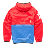 Back view of the award-winning About Town Anorak in vibrant Goji Berry color, featuring the Town Hall logo, reflective safety details, and elastic binding at hood and hem for weather protection during all outdoor adventures.