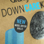 Cardboard packaging with text 'NEW WOOL DRYER BALLS' and a close-up of wool dryer balls.