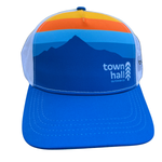 Blue cap with mountain design and 'town hall' logo on a white background