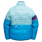 Back view of women's OuttaTown Reversible Jacket in aqua and blue with quilted panels and striped sleeve.
