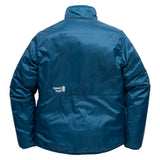 Back view of women's OuttaTown Reversible Jacket on its dark teal side with white Town Hall logo.