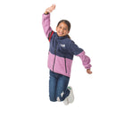 Girl jumping playfully in her Midtown Fleece Jacket in Mulberry with Black Iris, demonstrating how this flexible fleece coat moves with kids during active adventures.