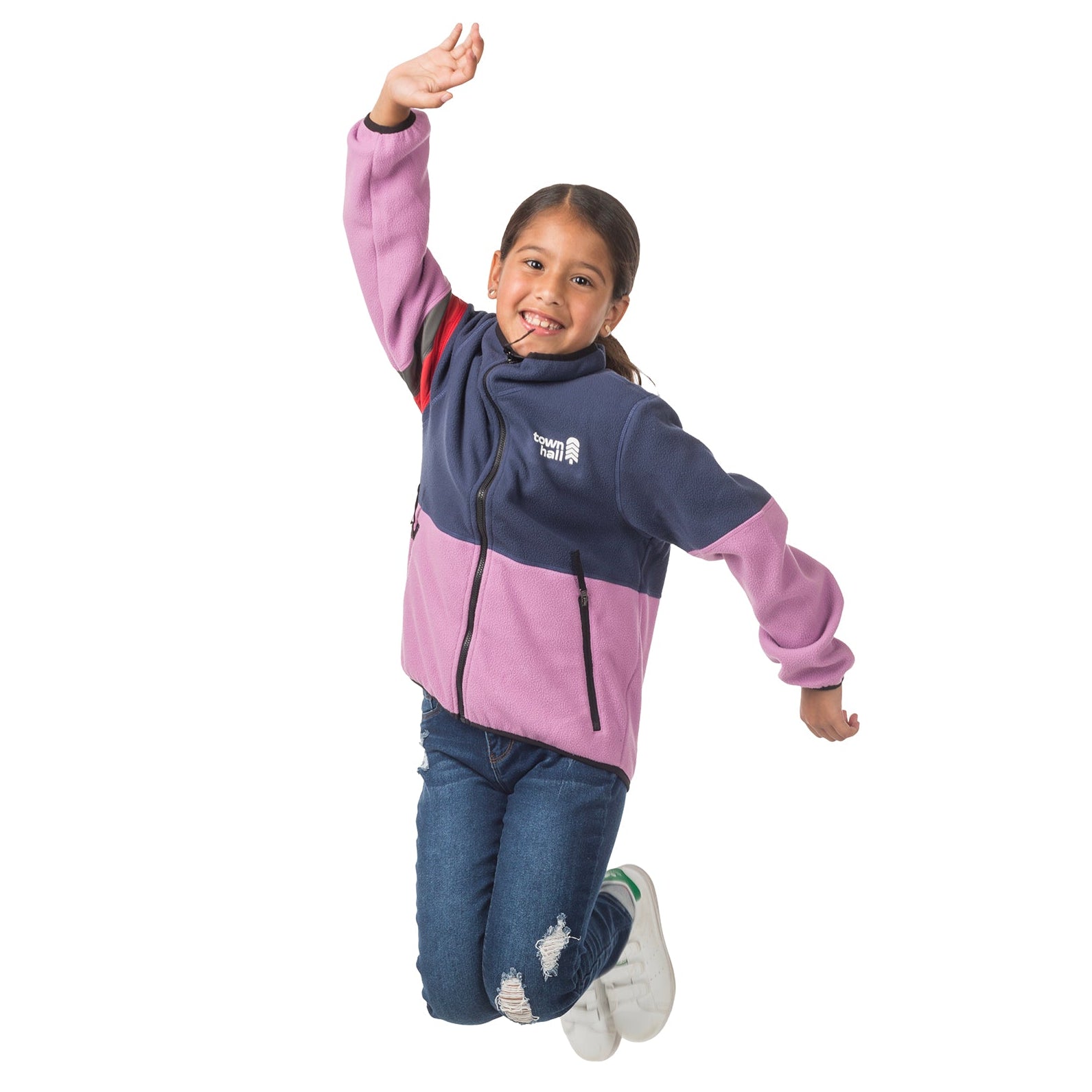 Girl jumping playfully in her Midtown Fleece Jacket in Mulberry with Black Iris, demonstrating how this flexible fleece coat moves with kids during active adventures.