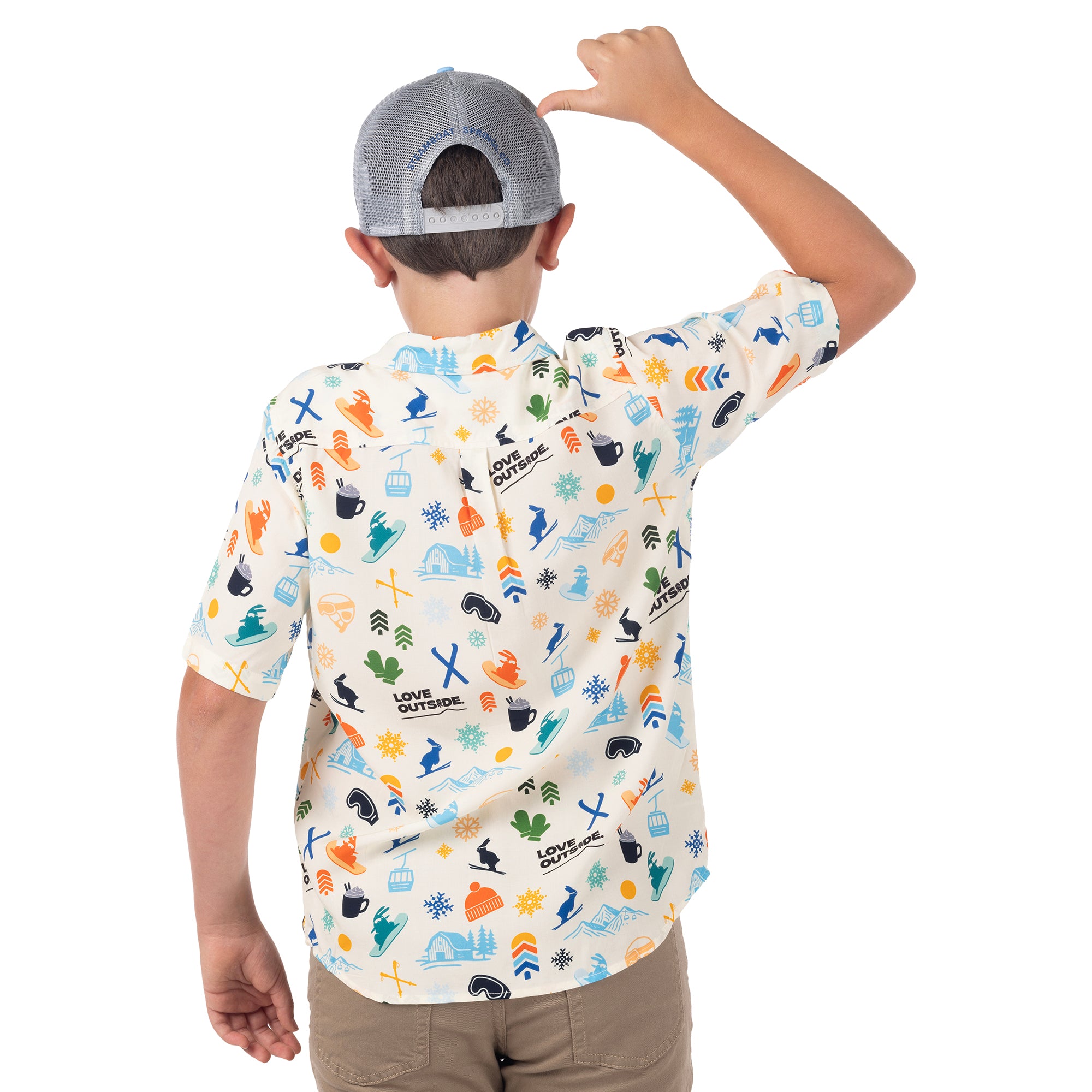 Child showing the gray mesh back and adjustable snapback of a Town Hall Trucker Hat, wearing a printed cabana shirt.