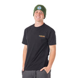 Young man wearing our cozy forest green Logo Knit Beanie, featuring the Town Hall brand logo on front, perfect for mountain adventures.