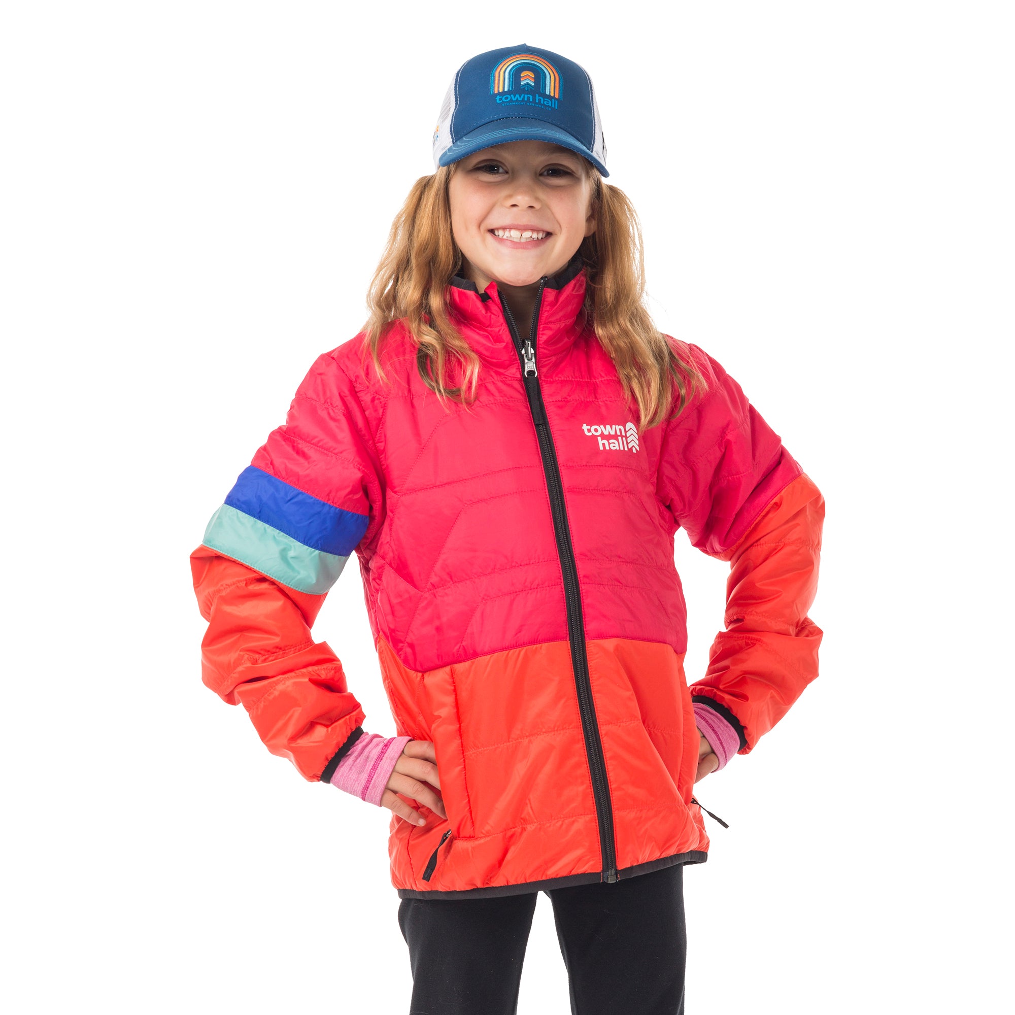 Girl wearing Town Hall's sustainable Kids Trucker Hat with playful rainbow design, paired with a Skip Town Insulated Jacket - perfect sun protection for outdoor adventures.