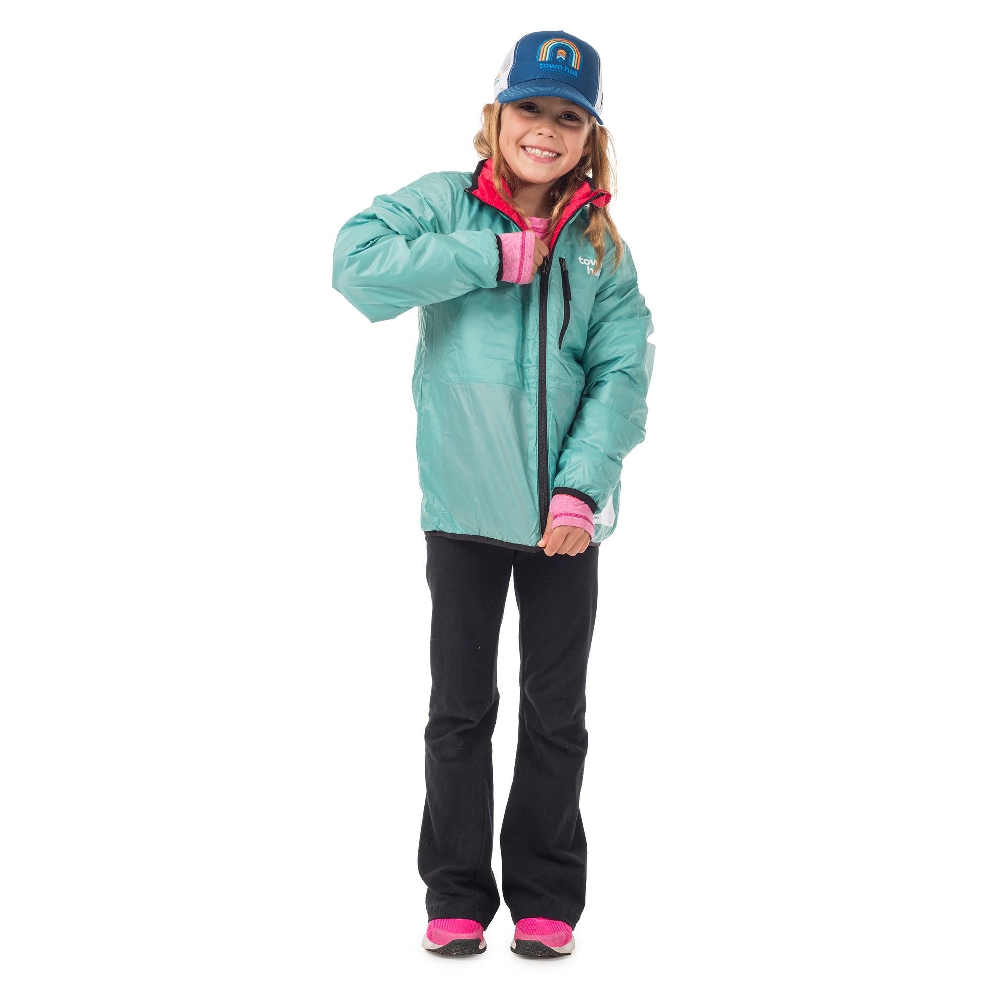 Girl showing the reversible side of our kids insulated coat, demonstrating how the Skip Town jacket transforms into a whole new look for versatile outdoor style.