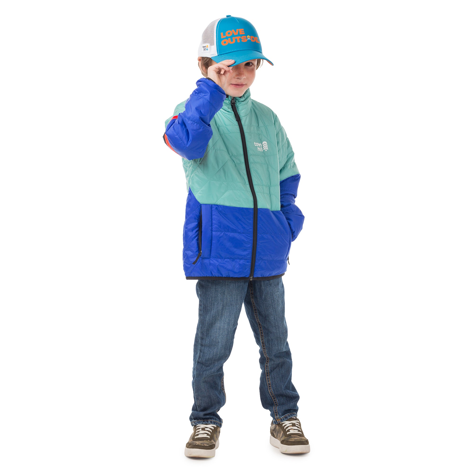 Boy wearing our Skip Town insulated jacket in Canton blue with Town Hall logo, perfect for playground adventures when a fleece is too light and a puffy's too much.
