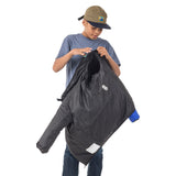 Teen boy flipping the Skip Town insulated jacket inside out, showing how easily kids can change looks when adventure takes them from cool mornings to warm afternoons.