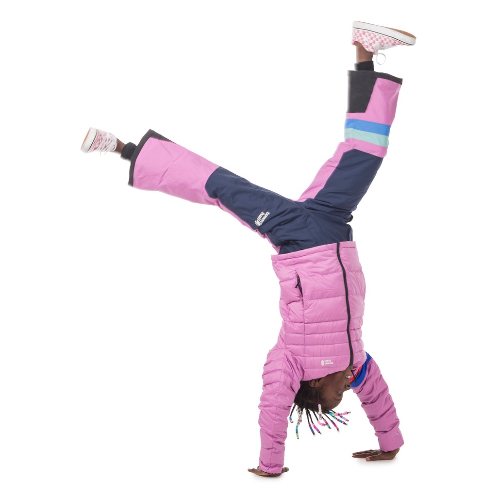 Child doing a handstand in Town Hall's Mulberry/Black Iris Winter Bib, showcasing the freedom of movement and secure fit that stays in place even during playful winter acrobatics.