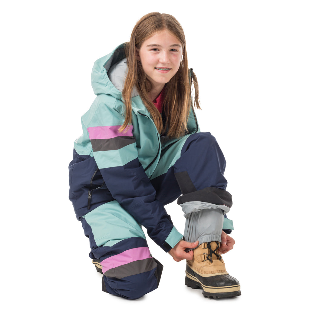 Girl in Town Hall's Canton/Black Iris Winter Bib demonstrating the internal leg gaiter that keeps snow out, a smart feature that keeps kids dry during sled rides and snowball fights.