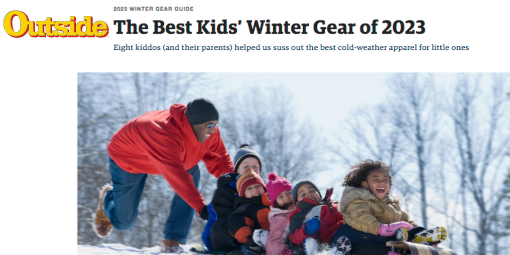 Outside Magazine Best Kids Winter Gear of 2023 - photo of dad pushing family on sled down hill in the snow. all smiles and playing.