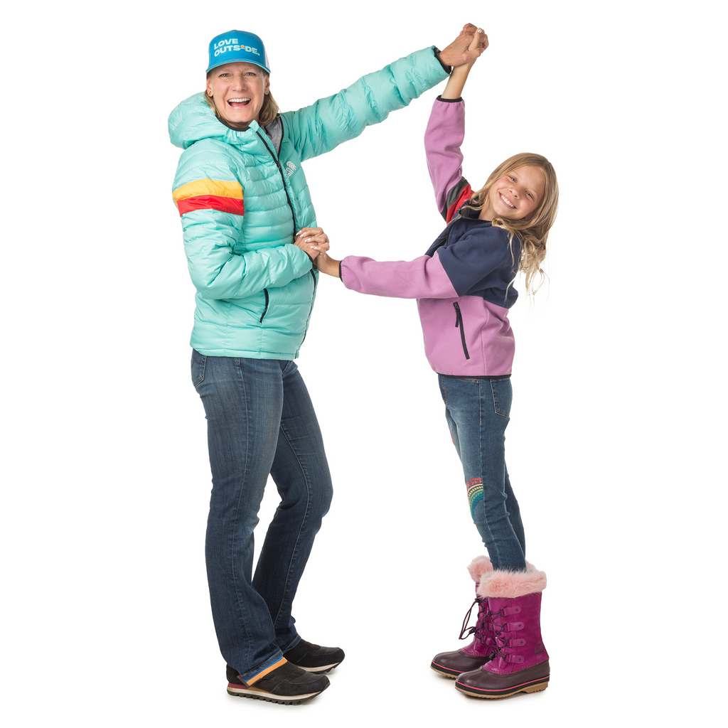 Adult woman and young girl in matching Town Hall Down Town Puffy jackets sharing a playful dance moment, showcasing how these sustainable jackets are designed for active outdoor families.