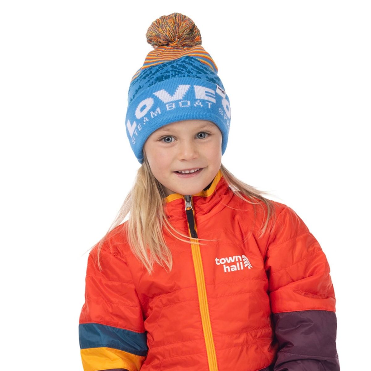 Child modeling the blue Kids Love Outside Beanie with white cuff lettering and multicolor pom-pom.