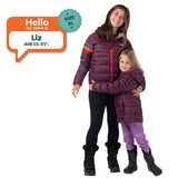 Liz, age 13, wearing a size XL Grape Jam Down Town Puffy jacket beside a younger child in a matching purple puffer.