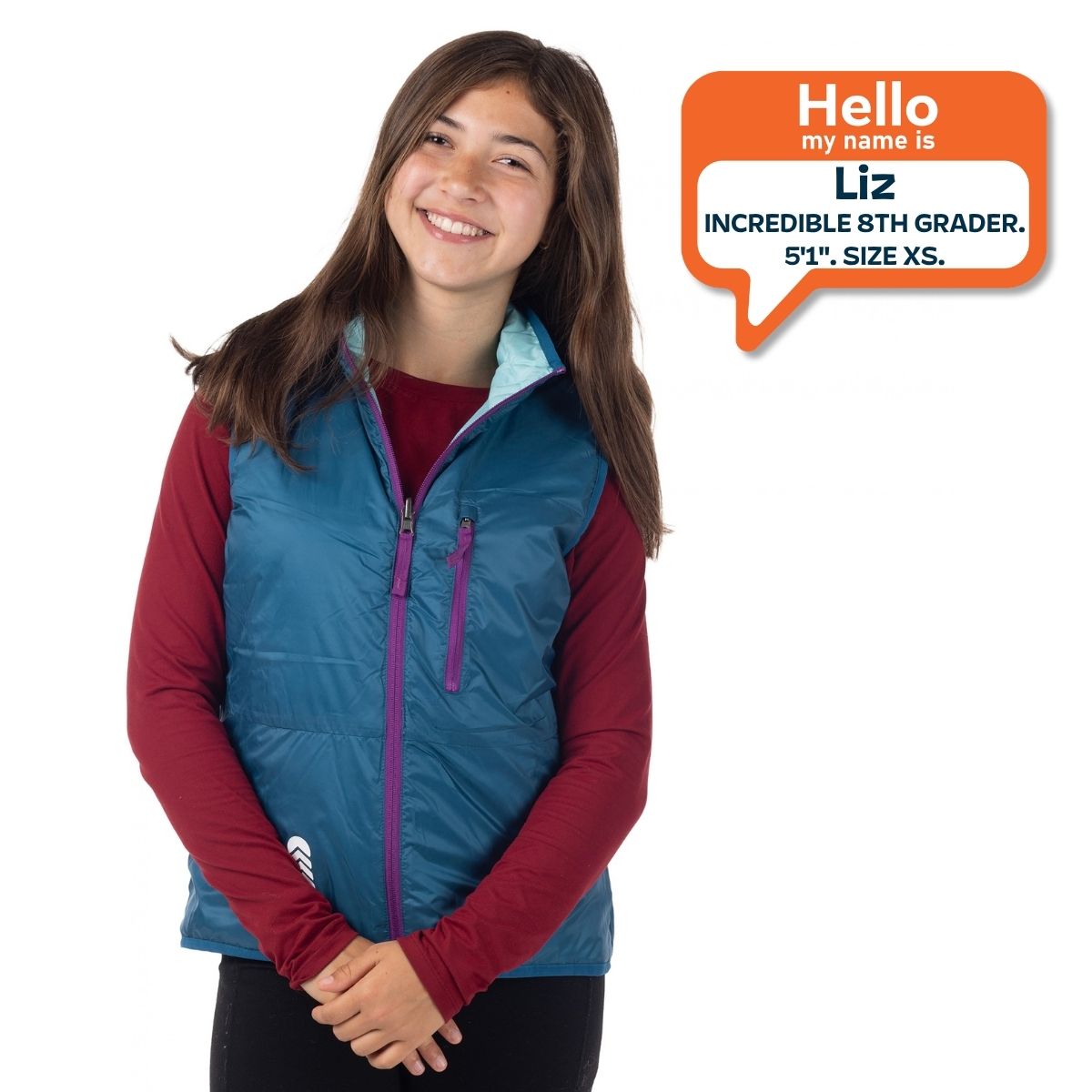 8th grade girl standing with XS size puffy vest on.