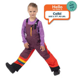 Colbi, age 5, wearing a size XXS Town Hall Mountain Town kids snow bib in Grape Jam purple and orange.