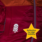 Red jacket with a reflective logo and text indicating high visibility.