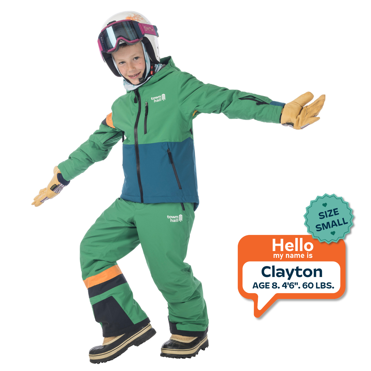 Child wearing a green and blue snowsuit with helmet and goggles, standing on a white background.