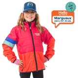 Child wearing a red and orange jacket with a blue cap, standing against a white background.