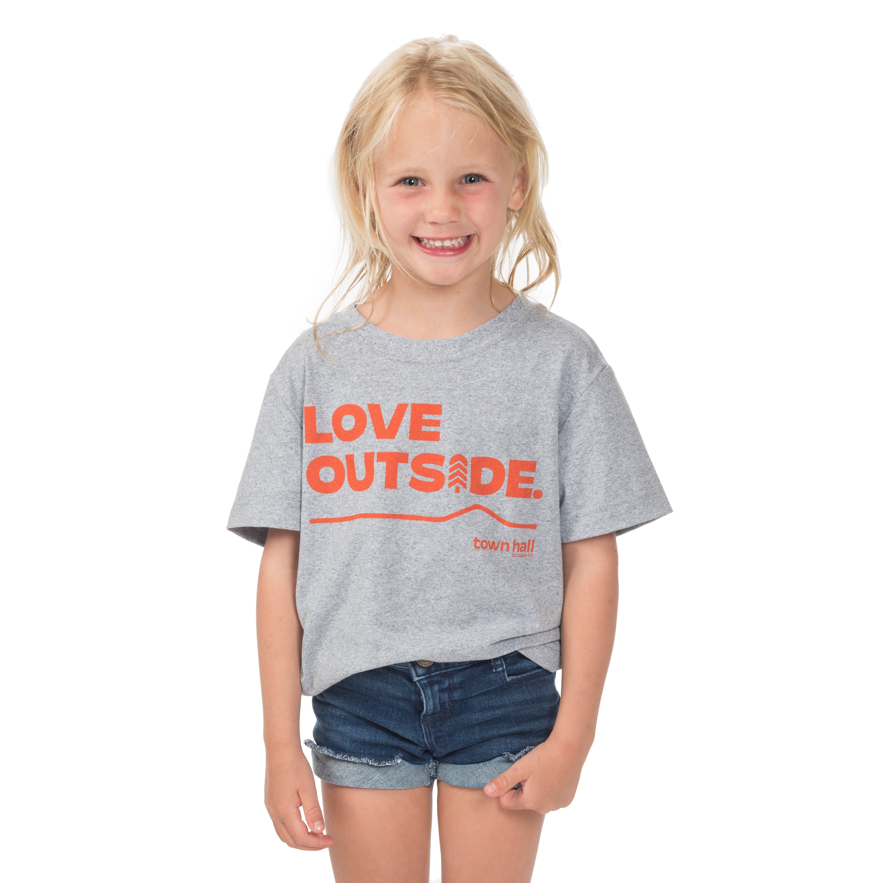 Young girl ready for outdoor adventures in our Heather Gray Kids Love Outside Tee with Town Hall logo and playful front message.