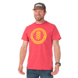 Front view of Town Hall's Ruby Steamboat Badge Tee modeled by man, showcasing the colorful community-inspired design and comfortable gender-neutral fit. 